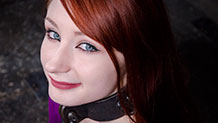 Beautiful Violet Monroe smiles up from her metal bondage