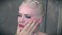 Dresden having her face pinched in rope bondage