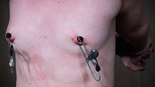 Dresden with nipple clamps and her arms in strappado