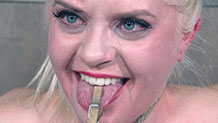 Dresden smiling with a clothespin on her tongue