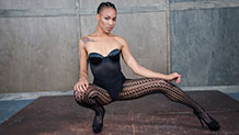 Nikki Darling beauty shot in sexy leotard, fishnets