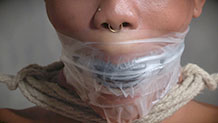 Nikki Darling in cloth, tape gag and neck rope